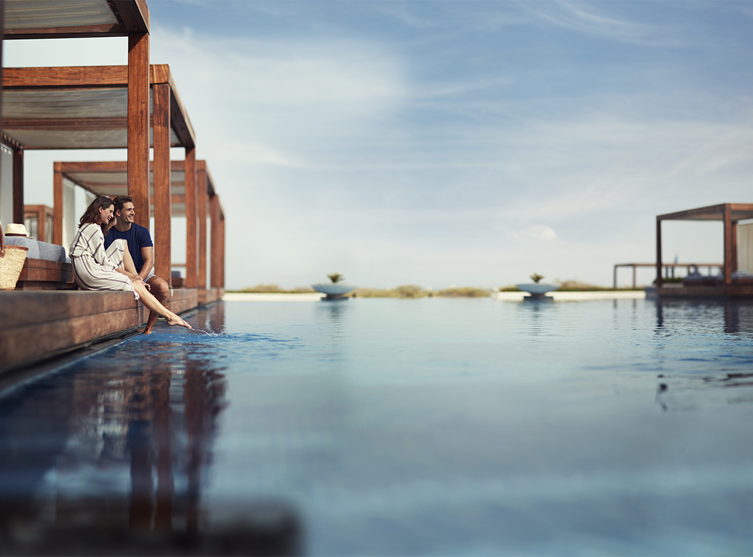 Couple poolside Saadiyat Island