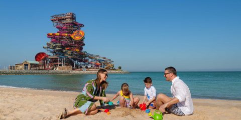 Family on the beach by Rixos Premium Qetaifan Island North