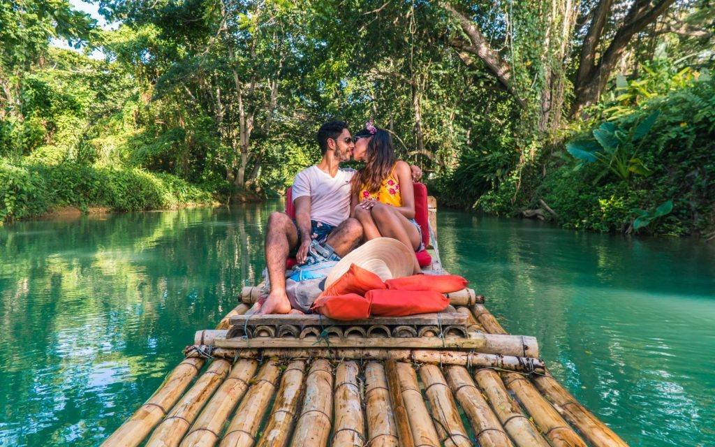 Couple taking a romantic boat ride down the Martha Brae river in Jamaica