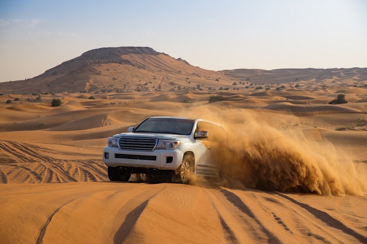 Car in Dubai sand dunes