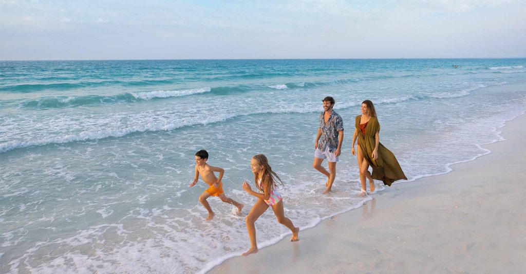 Family running along Kai Beach in Abu Dhabi