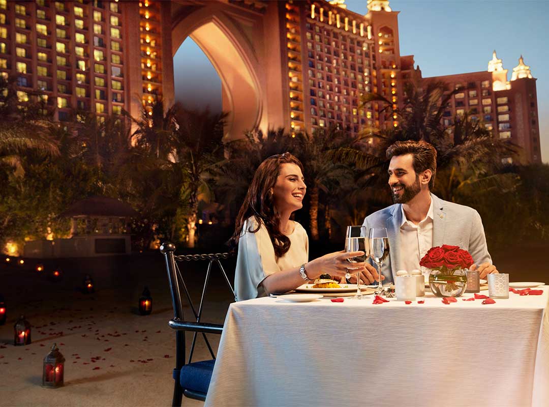 A couple dining on Royal Beach at Atlantis The Palm, Dubai