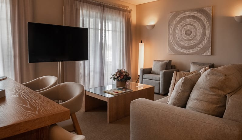 Elite Tropical One Bedroom ResidenceOpen-plan lounge, dining table for four, flat-screen TV, and contemporary lighting at Domes Lake Algarve by Kenwood Travel