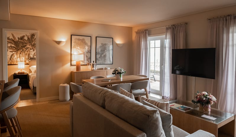 Elite Tropical One Bedroom ResidenceOpen-plan lounge, dining table for four, flat-screen TV, and contemporary lighting at Domes Lake Algarve by Kenwood Travel