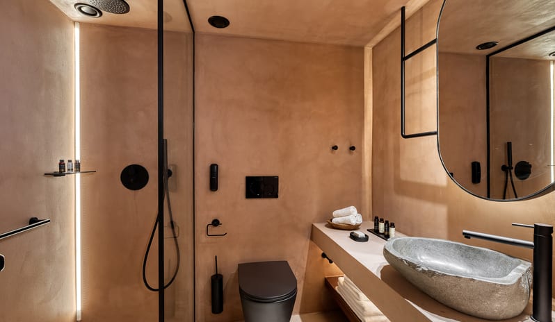 Inland Family Suite Luxury Mediterranean Style Bathroom with Stone Sink and Rain Shower at Domes of Corfu by Kenwood Travel