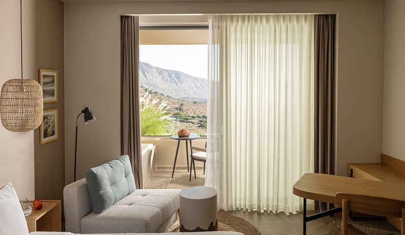 Bedroom Living Area at Domes Aulus Elounda Hotel in Europe by Kenwood Travel