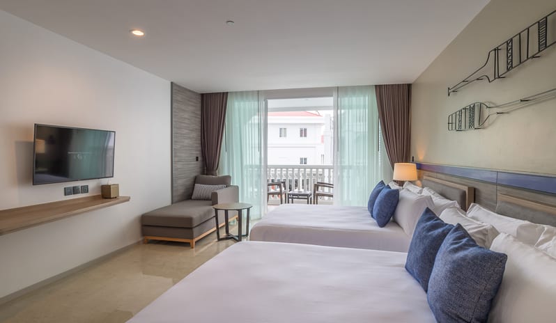 Premium Deluxe Pool Terrace Room with two queen beds, wall-mounted flat-screen TV, chaise lounge, and private furnished balcony at Centara Ao Nang Beach Resort & Spa Krabi by Kenwood Travel