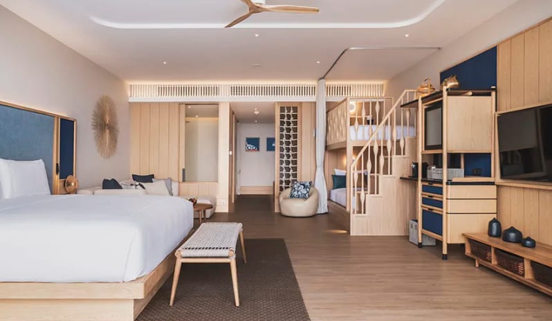 Family Pool View Suite king-sized bed, integrated wooden bunk beds for children, and coastal-themed living area at Anantara Koh Yao Yai Resort & Villas by Kenwood Travel