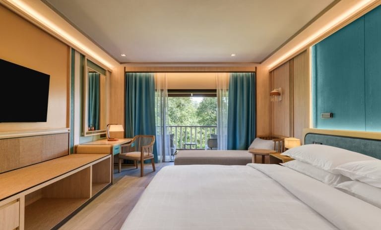 Deluxe Premium with Warm Ambient Lighting, Wood Paneling, and Teal Accents  at Dusit Thani Krabi Beach Resort by Kenwood Travel