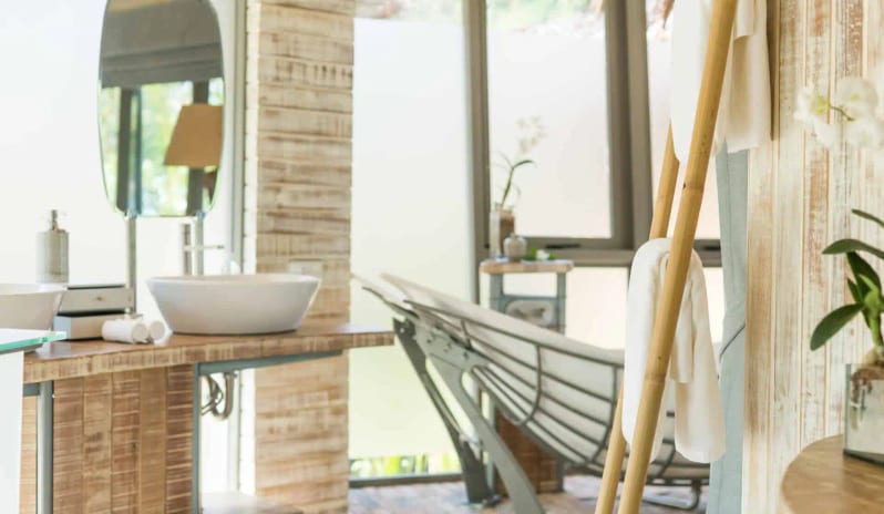 Modern Beachfront Bathroom Interior with Wooden Vanity, White Vessel Sink, Large Mirror, and Natural Light at TreeHouse Villas Koh Yao by Kenwood Travel