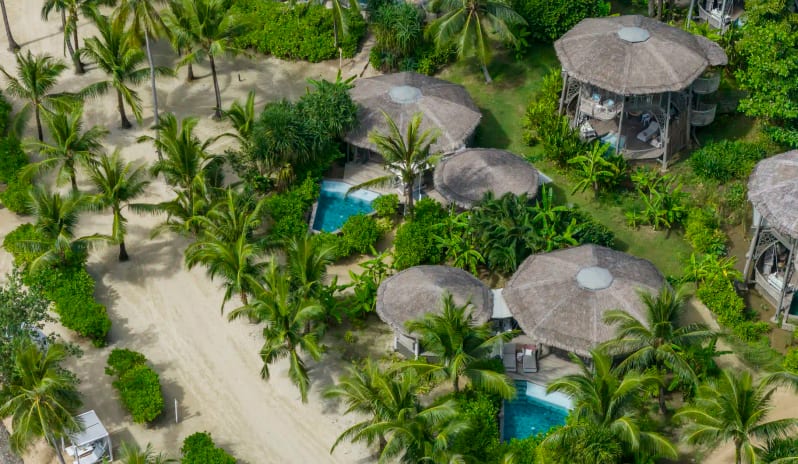 Aerial View of Luxury Beachfront Treehouse Villas with Thatched Roofs at TreeHouse Villas Koh Yao by Kenwood Travel
