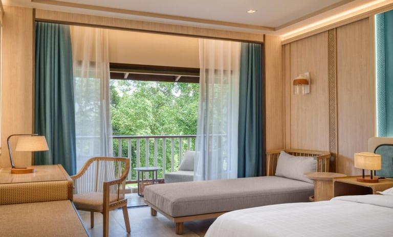 Deluxe Premium with Warm Ambient Lighting, Wood Paneling, and Teal Accents  at Dusit Thani Krabi Beach Resort by Kenwood Travel