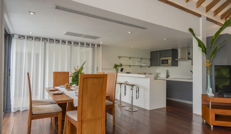 Hilltop Pool VillaDining and Kitchen Area with Open-Plan Layout, Wooden Furniture, and Contemporary Interiors at TreeHouse Villas Koh Yao by Kenwood Travel