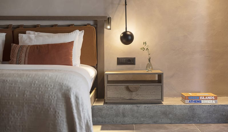 Tropical Bungalow Suite King-Sized Bed with Terracotta Pillows, Minimalist Hanging orb Lights, and a Built-in Wooden Desk Areaat Aulūs Lindos Rhodes, Curio Collection by Hilton by Kenwood Travel