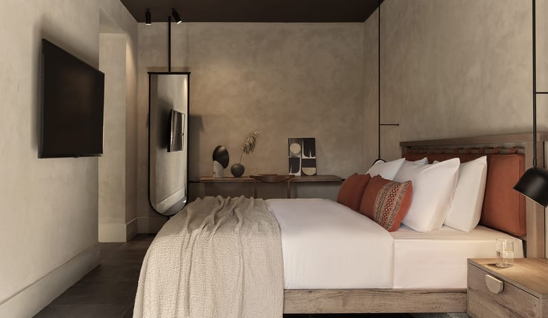 Tropical Cozy Retreat Bedroom with Earth-Toned Bedding, Terracotta Pillows, and Ambient Warm Lighting at Aulūs Lindos Rhodes, Curio Collection by Hilton by Kenwood Travel