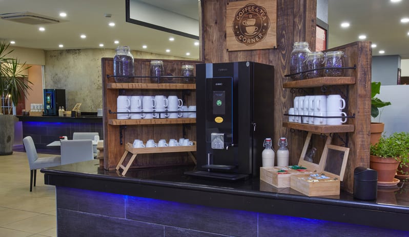 Cunucu Terrace Detailed view of a healthy breakfast bar with assorted whole fruits, sliced watermelon, and jars of grains or nuts in a restaurant setting at Divi Aruba All Inclusive Resort by Kenwood Travel