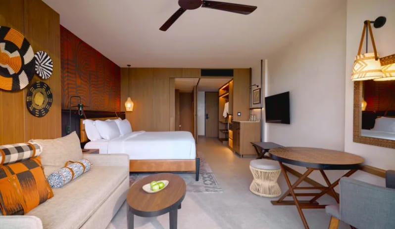 Premium Spa Explorer (King) Premium Spa Explorer room featuring king bed, seating area, and wooden interior finishes at Centara Grand Mirage Beah Resort by Kenwood Travel