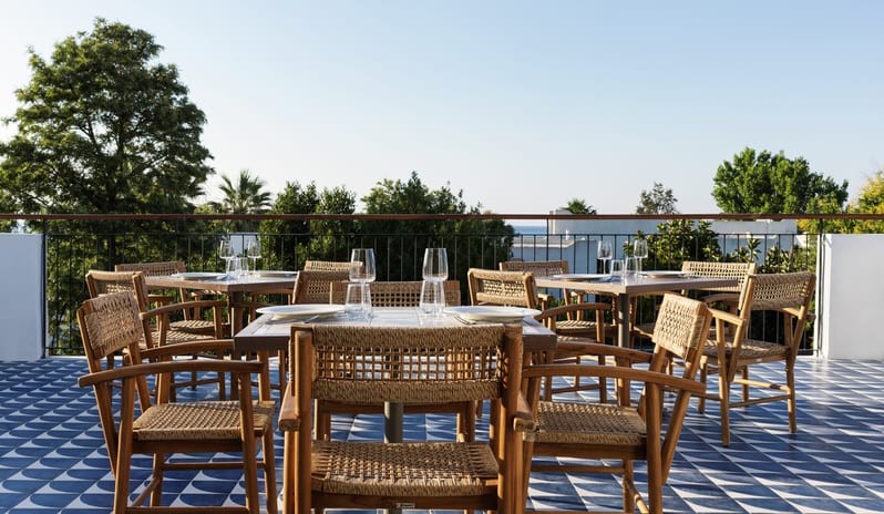 Meze Restaurant Mediterranean outdoor dining, rooftop restaurant design at Aulūs Lindos Rhodes, Curio Collection by Hilton by Kenwood Travel
