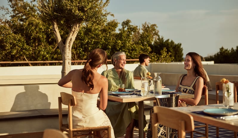 Meze Restaurant Outdoor dining experience, Mediterranean restaurant atmosphere, rooftop dinner with friends. at Aulūs Lindos Rhodes, Curio Collection by Hilton by Kenwood Travel