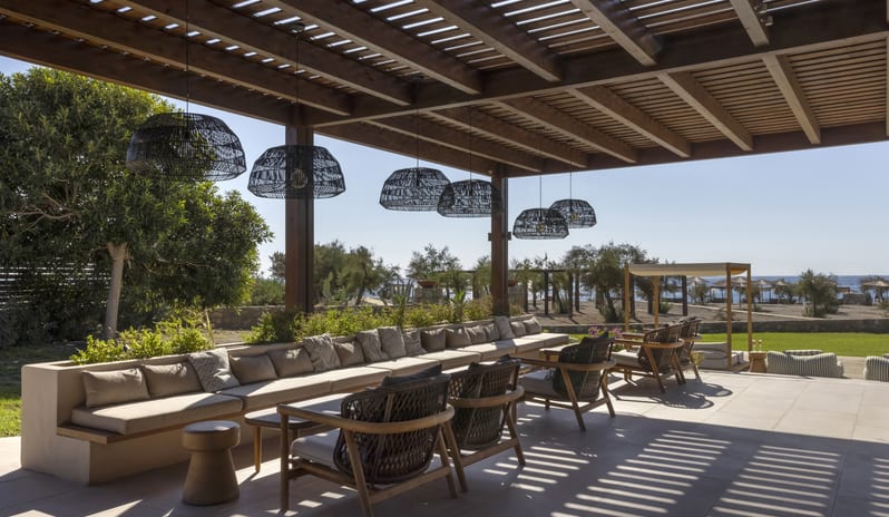 The Spiritzeria Shaded outdoor lounge at Aulūs Lindos Rhodes, Curio Collection by Hilton by Kenwood Travel
