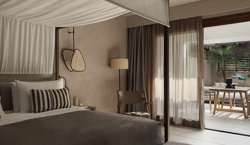 Tropical Bungalow Open Plan Suite with Outdor Jacuzzi Bedroom,Integrated Wooden Desk, and a Private Outdoor Terrace with Dining Area at Aulūs Lindos Rhodes, Curio Collection by Hilton by Kenwood Travel