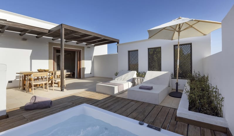 Tropical Bungalow Open Plan Suite with Outdor Jacuzzi Sun Loungers Under a Clear Blue Sky at Aulūs Lindos Rhodes, Curio Collection by Hilton by Kenwood Travel