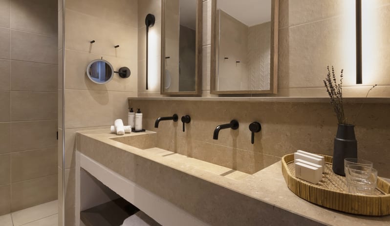 Tropical Bungalow Suite with Private Pool bathroom featuring a long integrated stone double vanity with matte black faucets at Aulūs Lindos Rhodes, Curio Collection by Hilton by Kenwood Travel