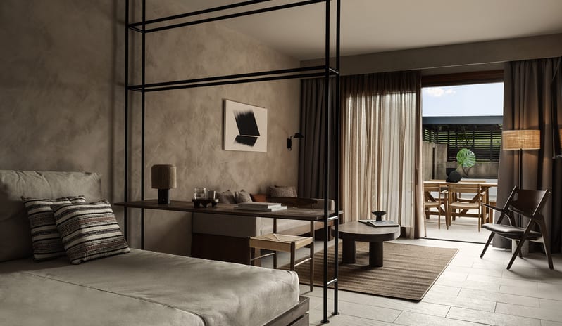 Tropical Pavilion One Bedroom Suite with Private Pool one-bedroom suite with textured plaster walls, a dark wood canopy bed at Aulūs Lindos Rhodes, Curio Collection by Hilton by Kenwood Travel