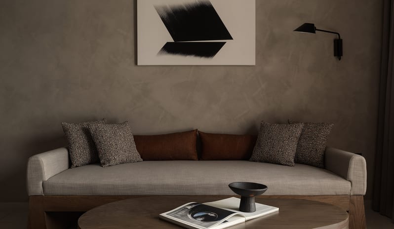 Tropical Pavilion One Bedroom Suite with Private Pool Contemporary living room featuring a low-profile wooden sofa with neutral upholstery, a large oval coffee table at Aulūs Lindos Rhodes, Curio Collection by Hilton by Kenwood Travel