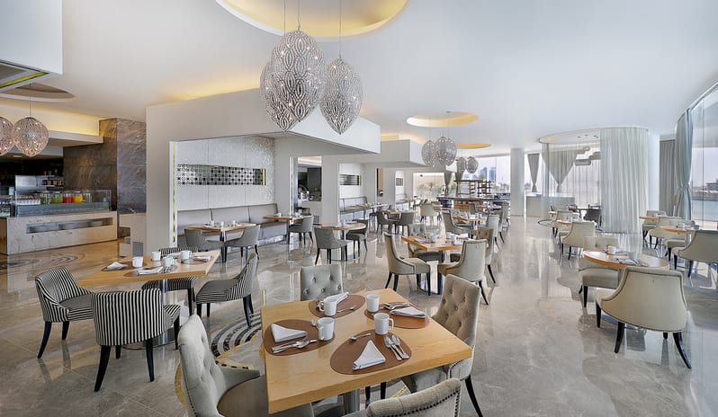 Rosewater Outdoor terrace restaurant seating with sea view at Conrad Abu Dhabi Etihad Towers by Kenwood Travel