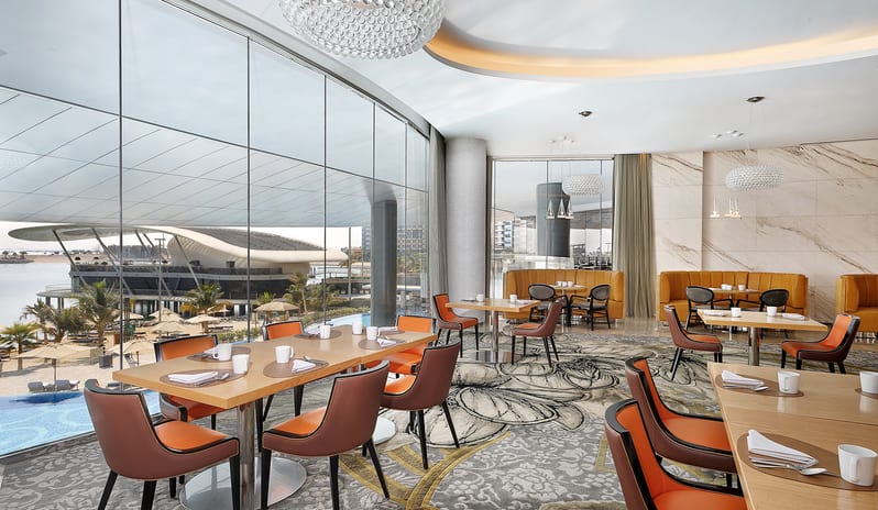 Rosewater Outdoor terrace restaurant seating with sea view at Conrad Abu Dhabi Etihad Towers by Kenwood Travel