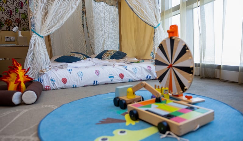 Premier Family Room with Sea View Kids play area inside a family hotel room featuring a cozy children’s tent bed, soft play mat, wooden toysat Conrad Abu Dhabi Etihad Towers by Kenwood Travel