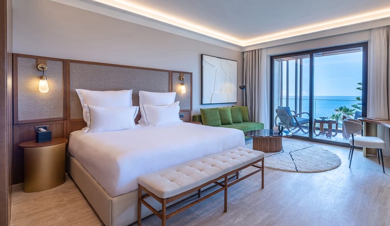 Sea View Escape Bedroom with balcony and modern furniture at Aulūs Chania, Curio Collection by Hilton by Kenwood Travel
