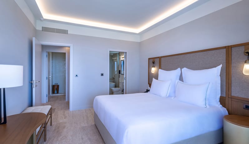 Sea View Escape Bedroom with balcony and modern furniture at Aulūs Chania, Curio Collection by Hilton by Kenwood Travel