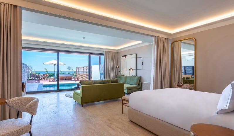 Sea View Grande Suite with Private Pool Bedroom green velvet sofa, and a private outdoor pool with ocean views at Aulūs Chania, Curio Collection by Hilton by Kenwood Travel