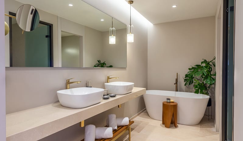 Sea View Grande Suite with Private Pool bathroom in the Sea View Grande Suite featuring double vessel sinks, gold fixtures, a freestanding soaking tub at Aulūs Chania, Curio Collection by Hilton by Kenwood Travel