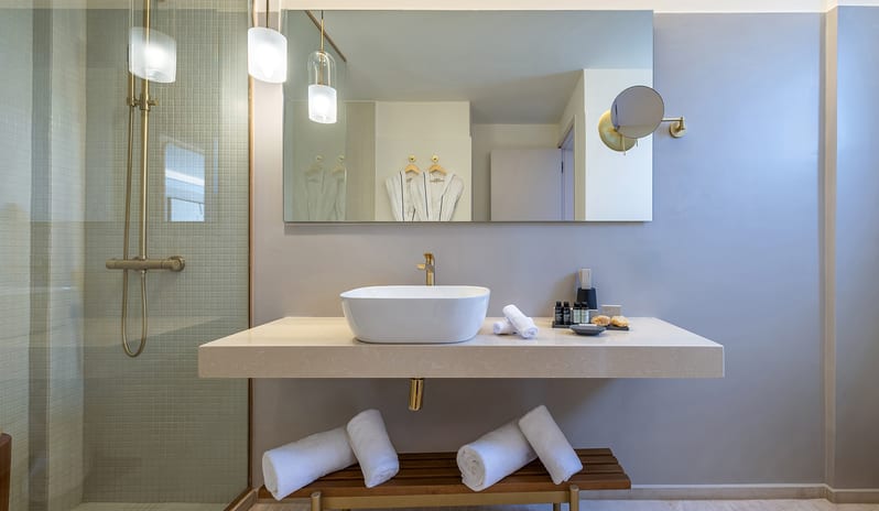 Tropical Open Plan Suite (with shared pool) bathroom featuring a floating stone vanity with a vessel sink at Aulūs Chania, Curio Collection by Hilton by Kenwood Travel