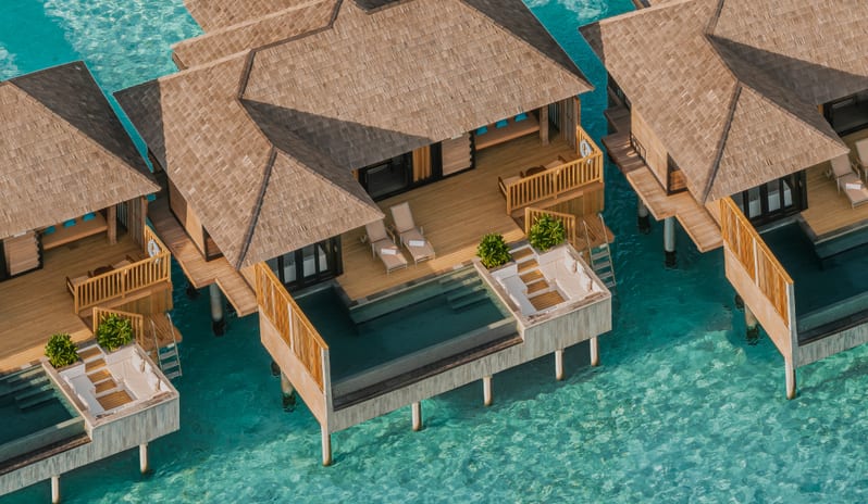 Sunset Horizon Water Villa with Pool Luxury overwater villa resort with private pools and sun decks situated over clear turquoise ocean water at Sun Siyam Iru Fushi-Sunset Horizon Water Villa with Pool  by Kenwood Travel