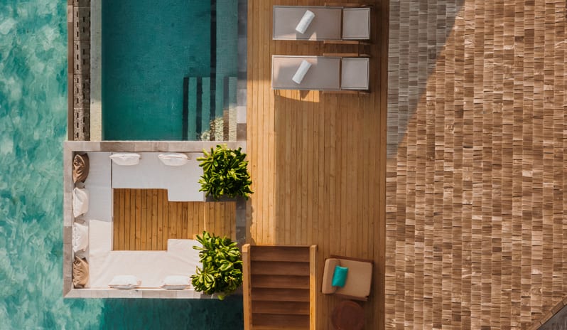 Sunset Horizon Water Villa with Pool Luxury overwater villa resort with private pools and sun decks situated over clear turquoise ocean water at Sun Siyam Iru Fushi-Sunset Horizon Water Villa with Pool  by Kenwood Travel