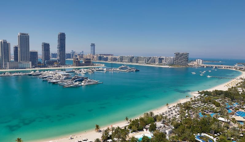 Family Suite Panoramic daytime view of the turquoise waters of Dubai Marina, luxury yachts at the docks, and the white sandy beach of Mina Seyahi at W Dubai - Mina Seyahi by Kenwood Travel