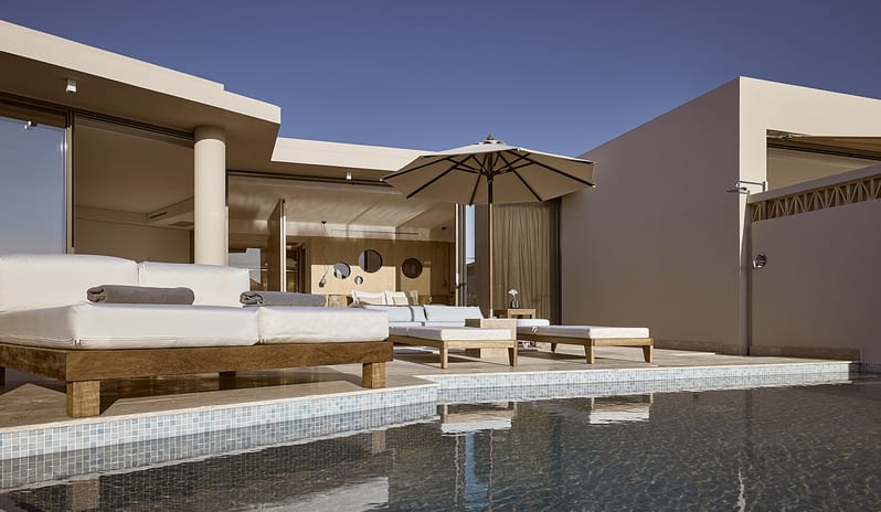 Olives & Sea 3-Bedroom Villa Private Pool Harbour View/Sea View tprivate terrace with a tiled pool, premium sunbeds, a white patio umbrella, and modern Mediterranean architecture at St.Nicolas Bay Resort by Kenwood Travel