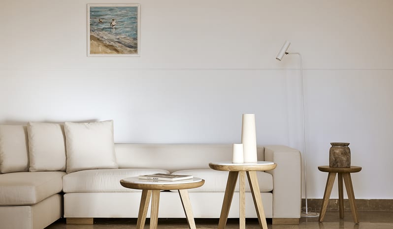 Olives & Sea 3-Bedroom Villa Private Pool Harbour View/Sea View cream sectional sofa, nested wooden coffee tables with marble tops, a sleek floor lamp, and coastal-themed wall art at St.Nicolas Bay Resort by Kenwood Travel