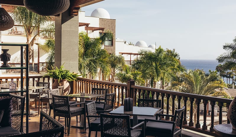 Grand atrium view of the Lobby Bar with tropical plants, wooden balconies, and natural light at Princesa Yaiza Suite Hotel Resort in Europe Holidays by Kenwood Travel