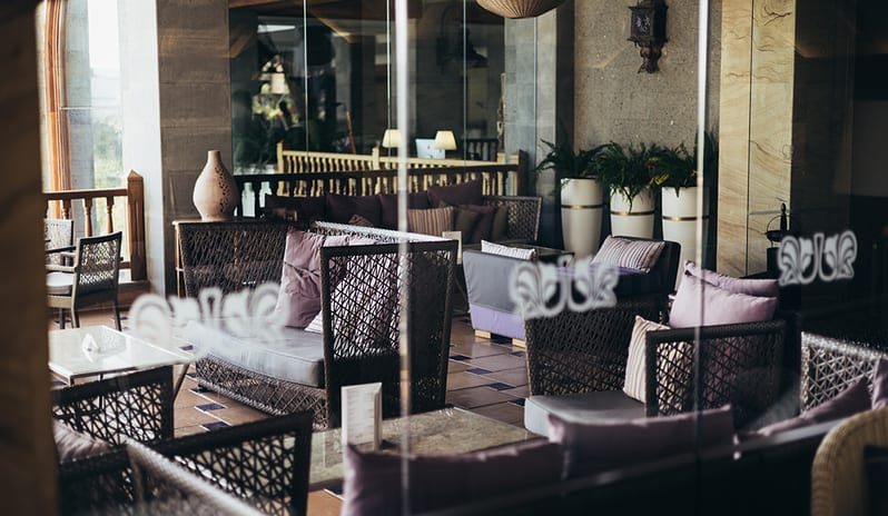 Close-up of two elegant cocktails on a table with a piano and stage in the background at Princesa Yaiza Suite Hotel Resort in Europe Holidays by Kenwood Travel