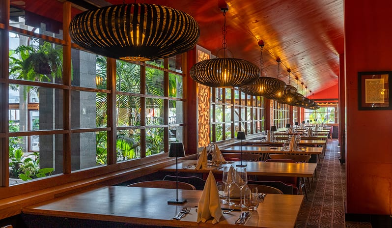 Elegant window-side dining tables at Kampai with views of tropical greenery at Princesa Yaiza Suite Hotel Resort in Europe Holidays by Kenwood Travel