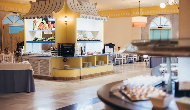 Main indoor dining hall of Yaiza Buffet with classic decor and round tables at Princesa Yaiza Suite Hotel Resort in Europe Holidays by Kenwood Travel