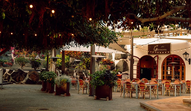 Romantic outdoor terrace at Don Giovanni restaurant with fairy lights and lush greenery at Princesa Yaiza Suite Hotel Resort in Europe Holidays by Kenwood Travel