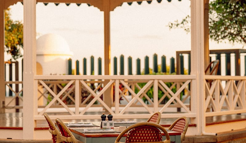 Outdoor patio dining area at Don Giovanni with a decorative blue and white gazebo and string lights at Princesa Yaiza Suite Hotel Resort in Europe Holidays by Kenwood Travel