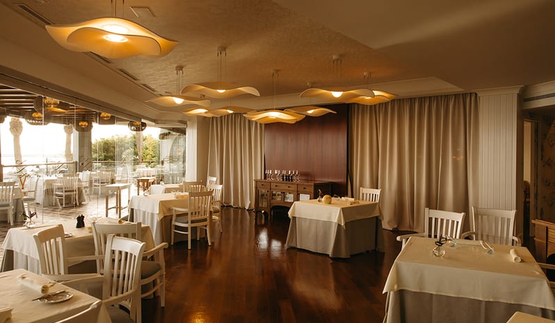 Modern interior dining room of Isla de Lobos with unique floral-inspired ceiling lights and wooden flooring at Princesa Yaiza Suite Hotel Resort in Europe Holidays by Kenwood Travel