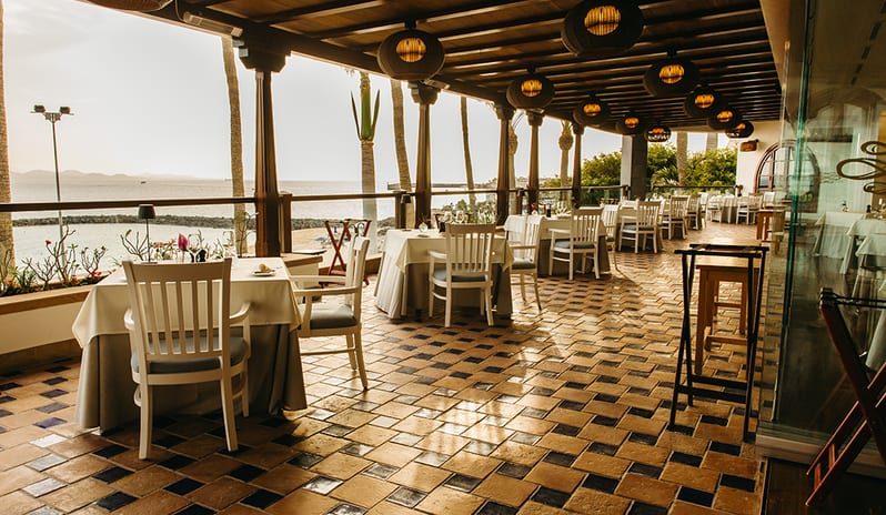 Panoramic outdoor terrace at Isla de Lobos overlooking the ocean and beach at sunset at Princesa Yaiza Suite Hotel Resort in Europe Holidays by Kenwood Travel